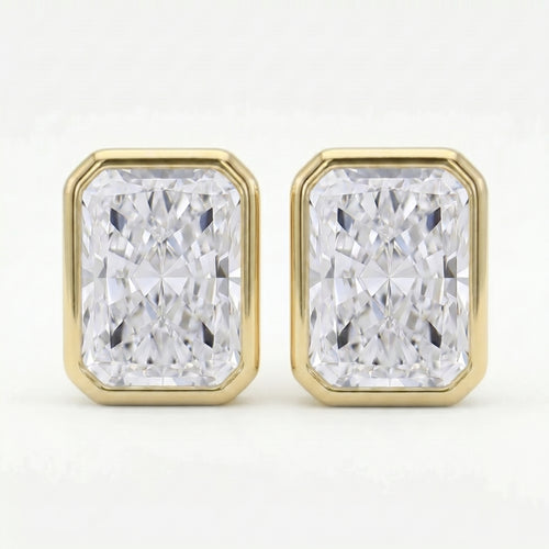 Gold earrings with rectangular diamond-like stones on a white background