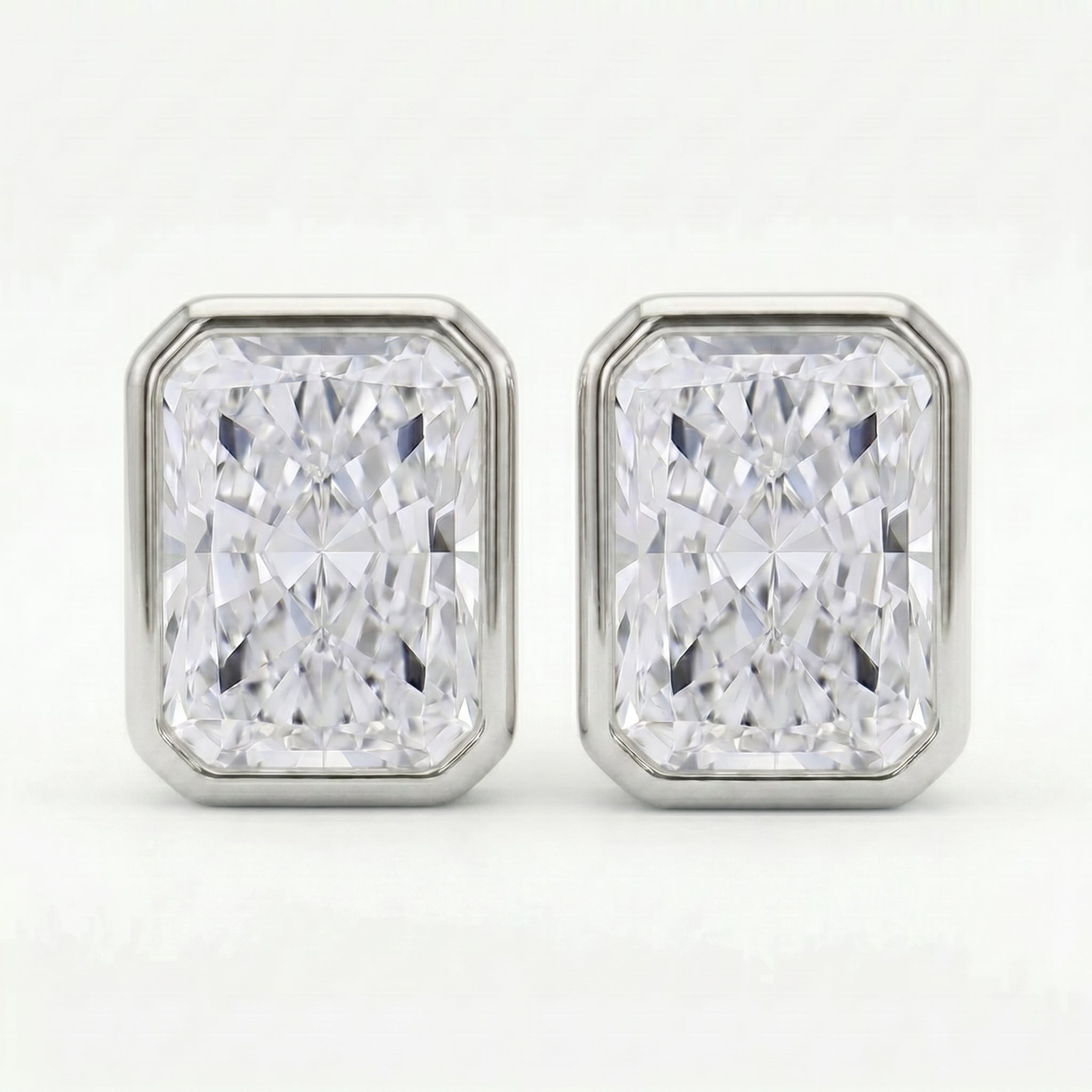 Pair of diamond stud earrings on a white background