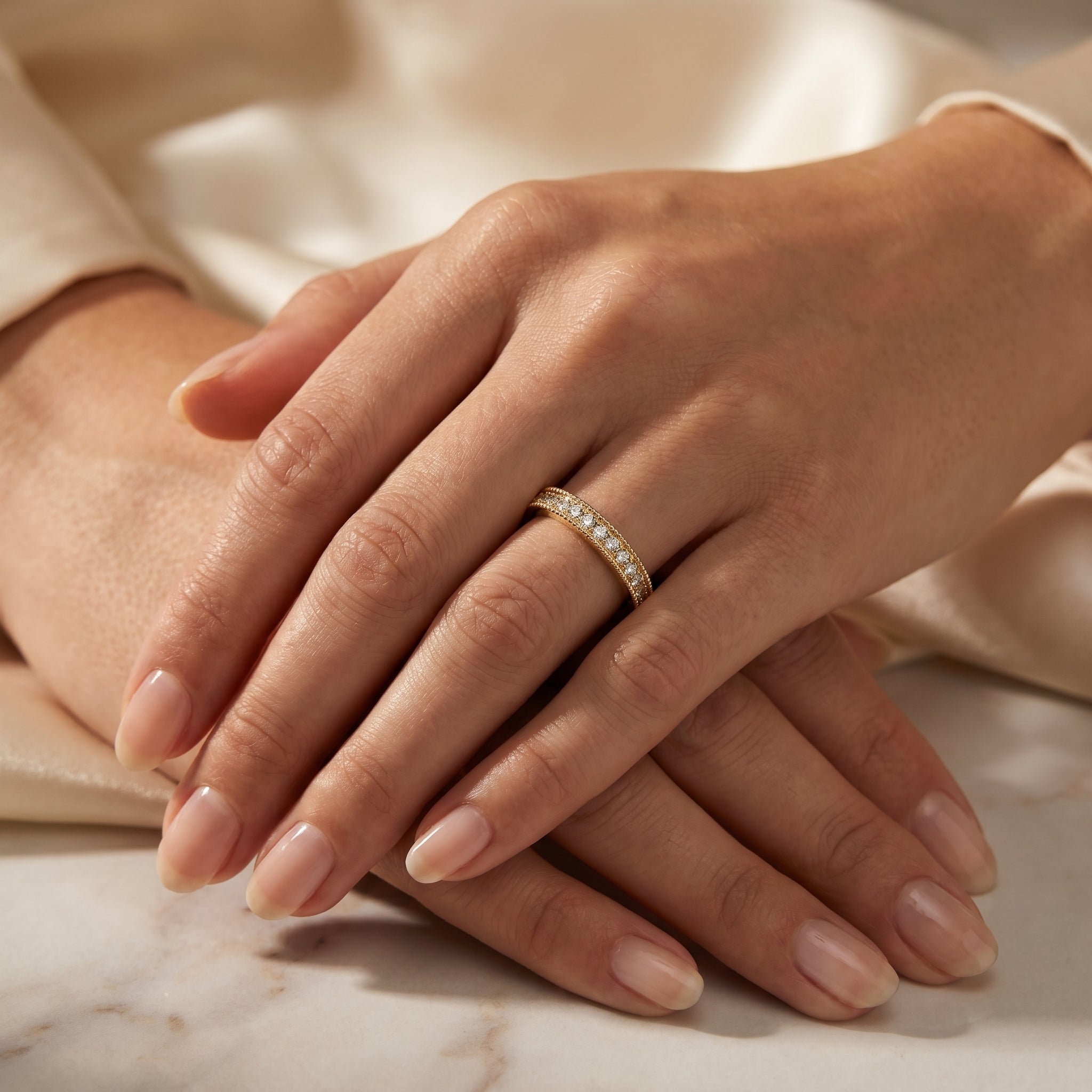 Woman wearing yellow gold diamond eternity band showcasing elegant stackable fine jewelry styling