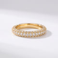 Yellow gold diamond eternity band with three rows of round brilliant pavé diamonds on a pure white background, luxury wedding ring.