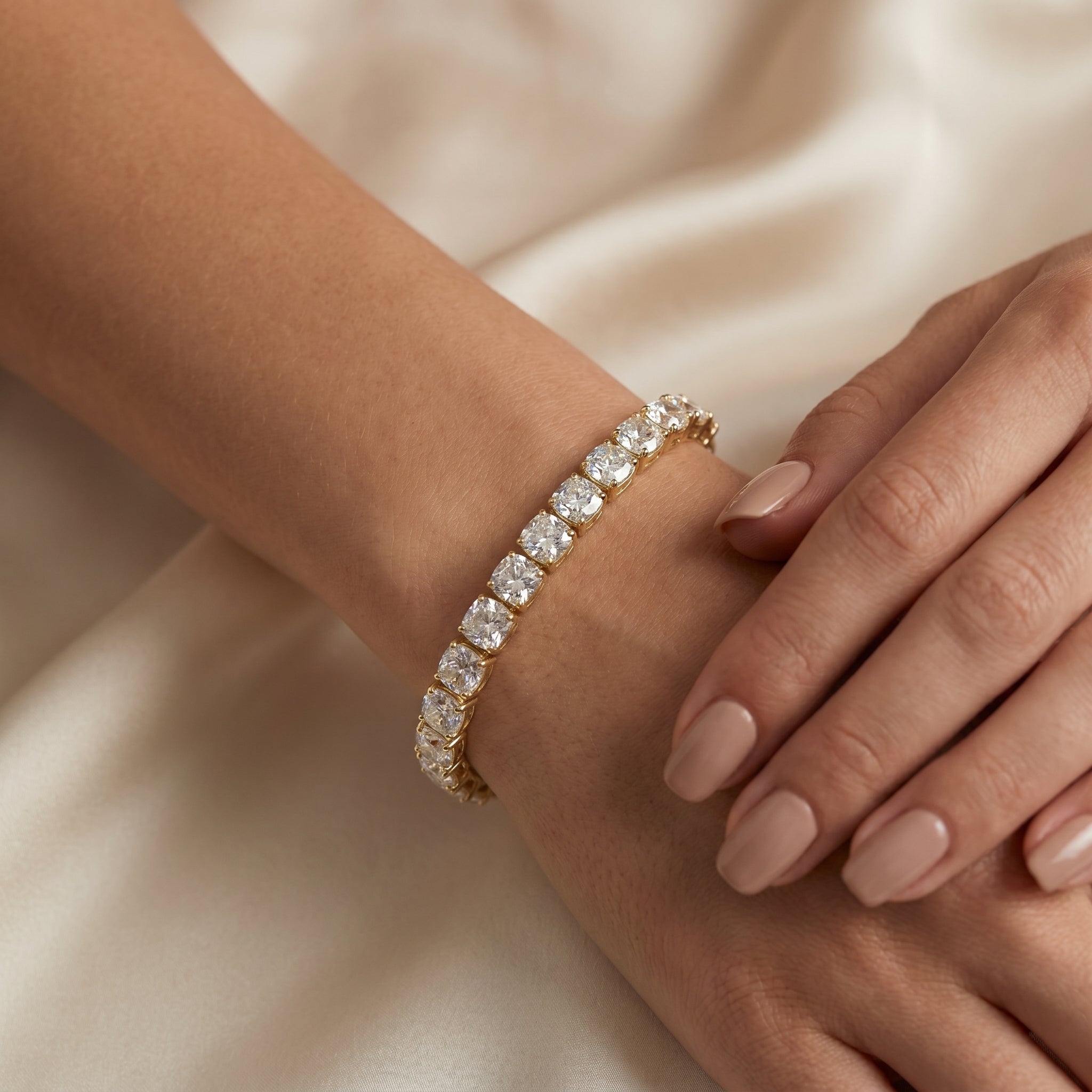 Close-up of yellow gold tennis bracelet showcasing Cushion-cut stones, premium craftsmanship and brilliant shine