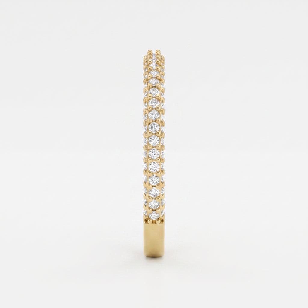 Side profile of a yellow gold eternity ring highlighting round brilliant diamonds and elegant shared prong craftsmanship.