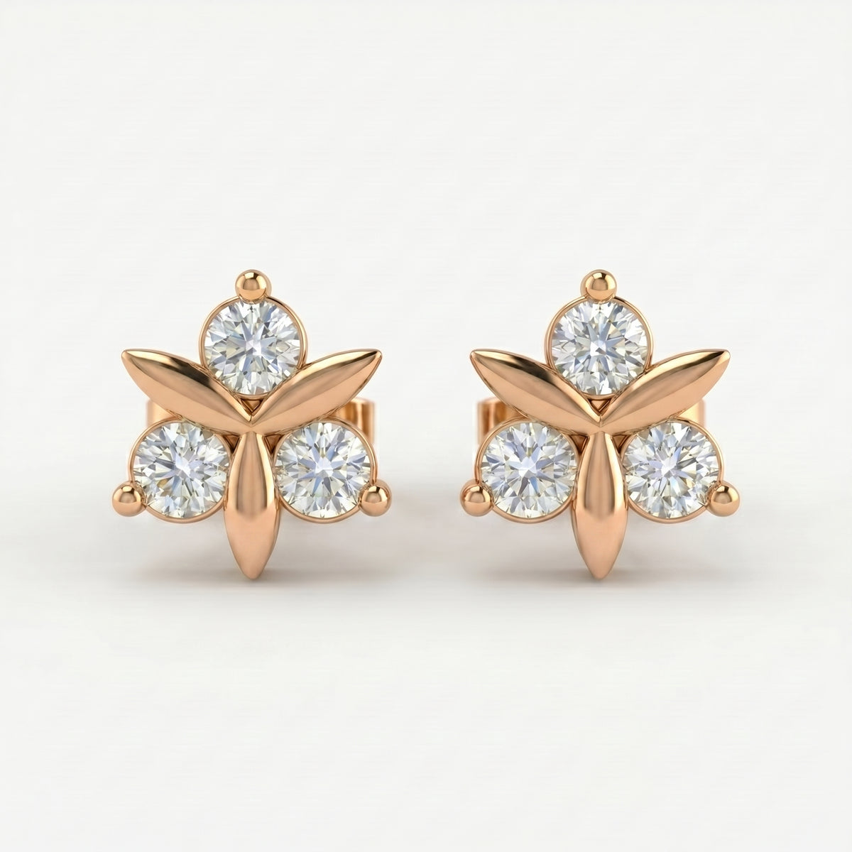 Rose gold floral stud earrings with round brilliant stones on white background, minimalist luxury jewelry design