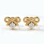 Macro close-up of bow earrings with brilliant round crystal and polished premium metal detailing