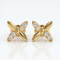 Flat lay butterfly diamond earrings styled with elegant luxury accessories on a clean white background
