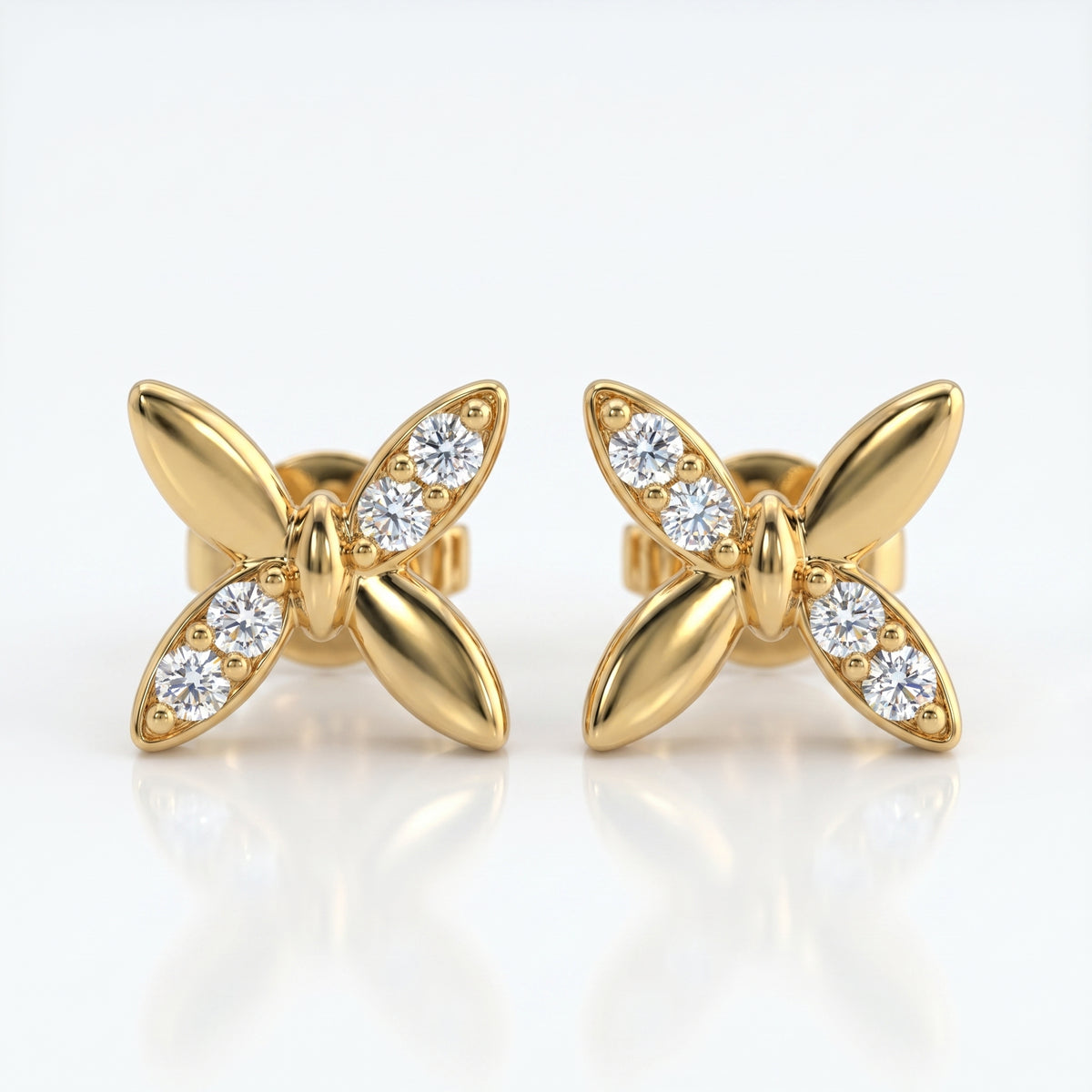Flat lay butterfly diamond earrings styled with elegant luxury accessories on a clean white background