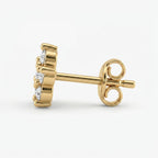 Macro close-up of floral diamond earrings highlighting brilliant sparkle and fine gold detailing