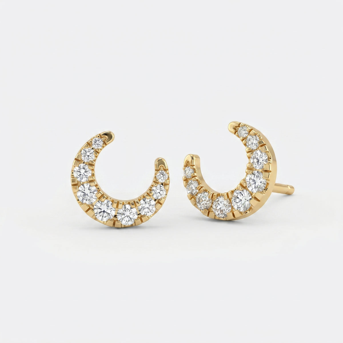 Side profile of yellow gold crescent diamond earrings showing premium pavé craftsmanship details