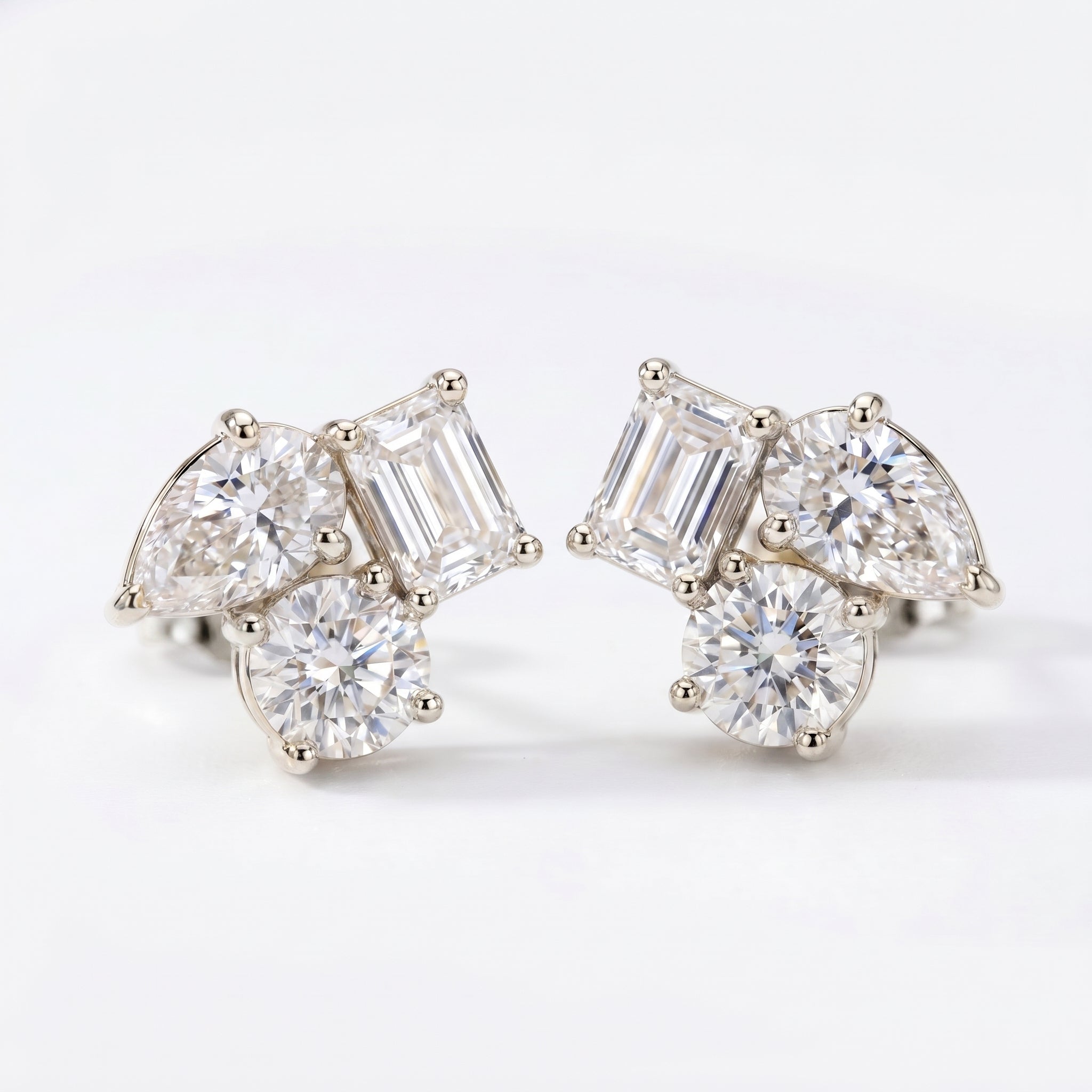 Luxury cluster stud earrings in rose gold with mixed diamond cuts shown at 45 degree angle