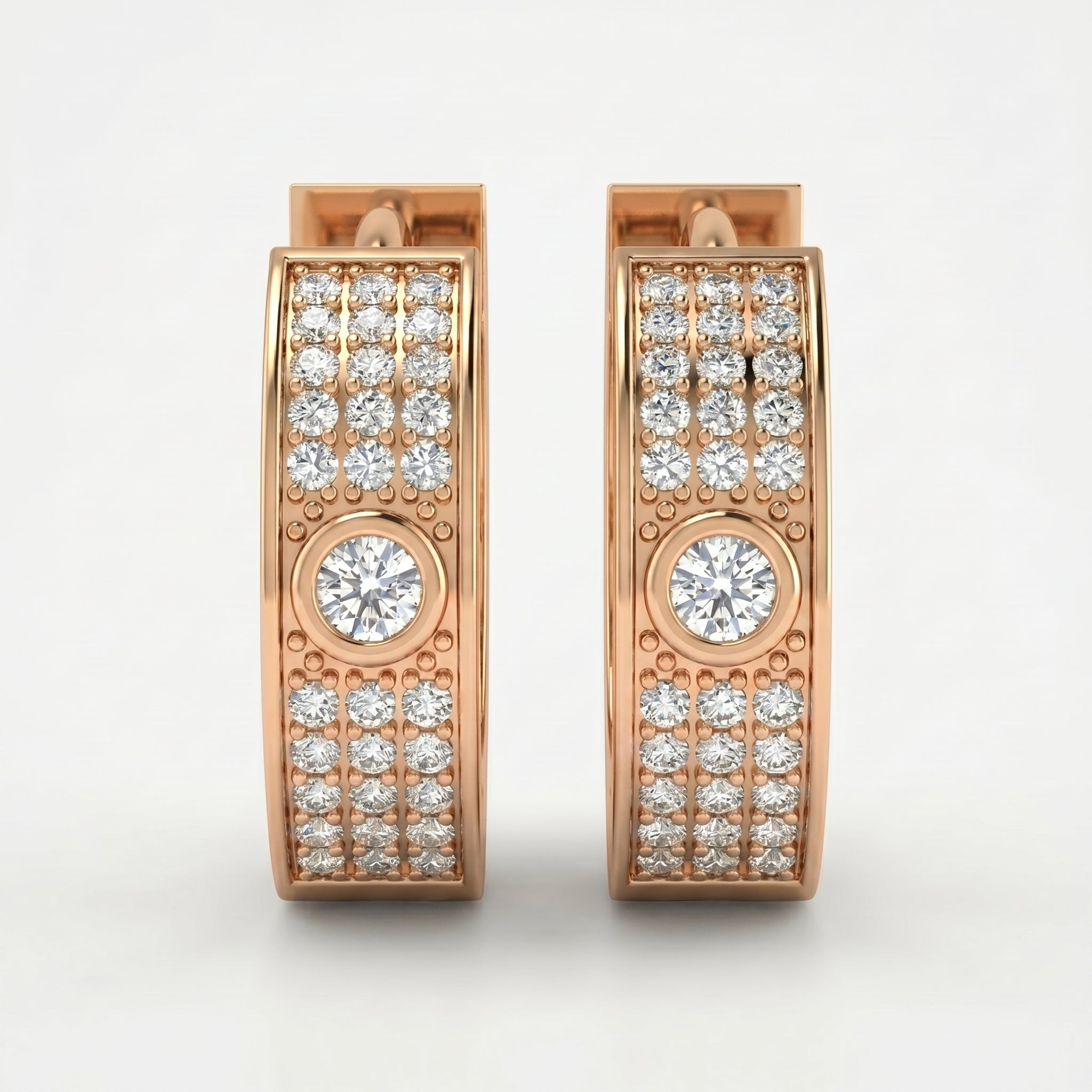Rose gold diamond huggie hoop earrings with pavé stones and bezel-set center diamonds on white background