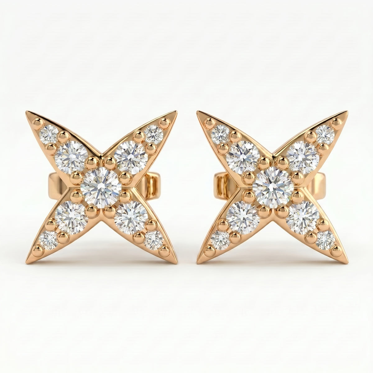 Luxury diamond star stud earrings at 45 degree angle showing pavé detailing and polished gold craftsmanship