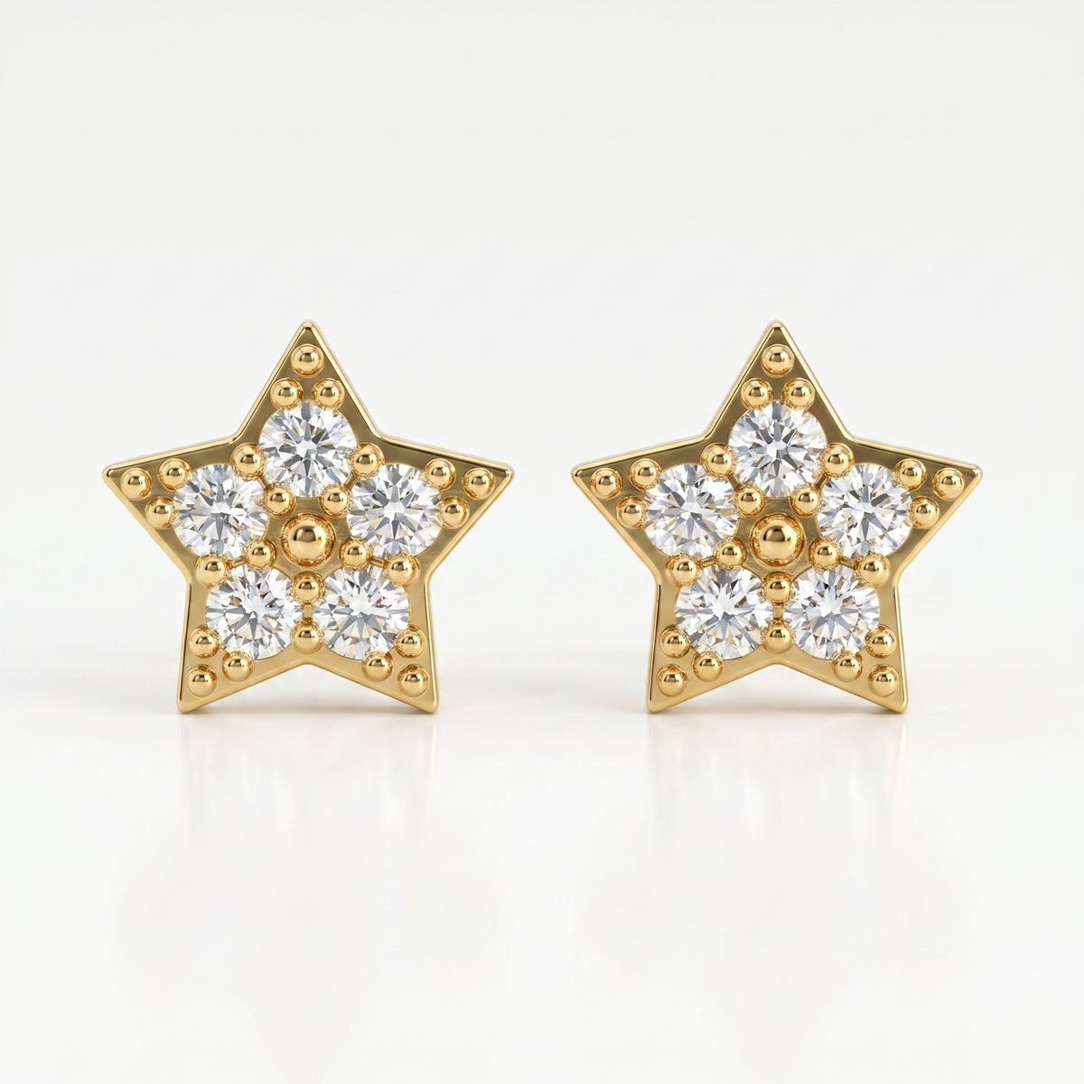 Macro close-up of pavé diamond star earrings showing sparkling stones and intricate gold bead detailing