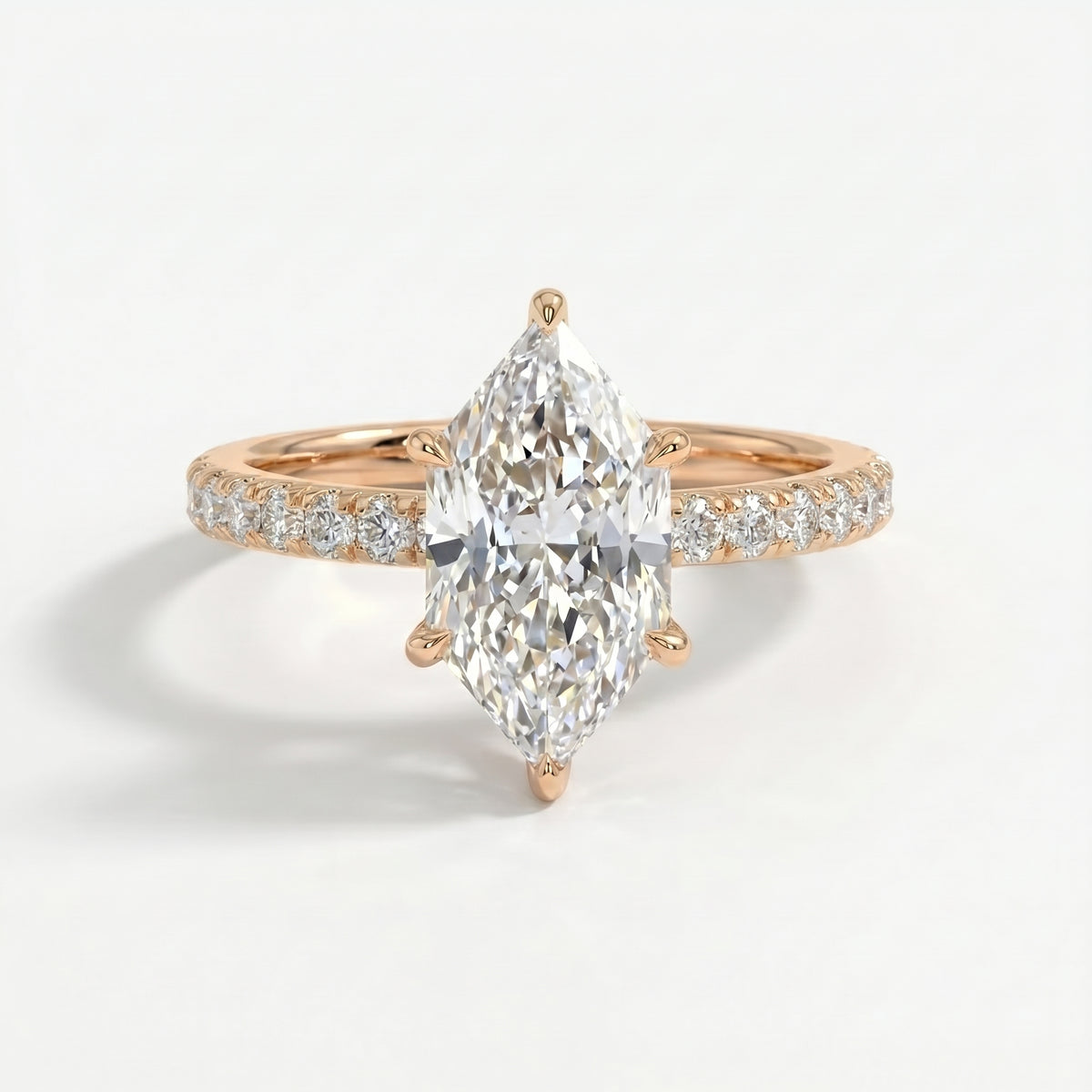 Marquise cut diamond engagement ring with pavé diamond band in rose gold, luxury bridal jewelry front view