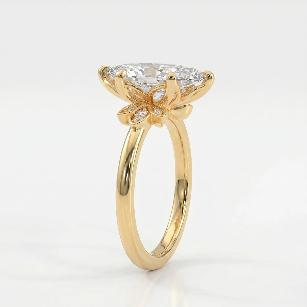45 degree view of marquise diamond engagement ring featuring yellow gold floral setting and brilliant accent stones