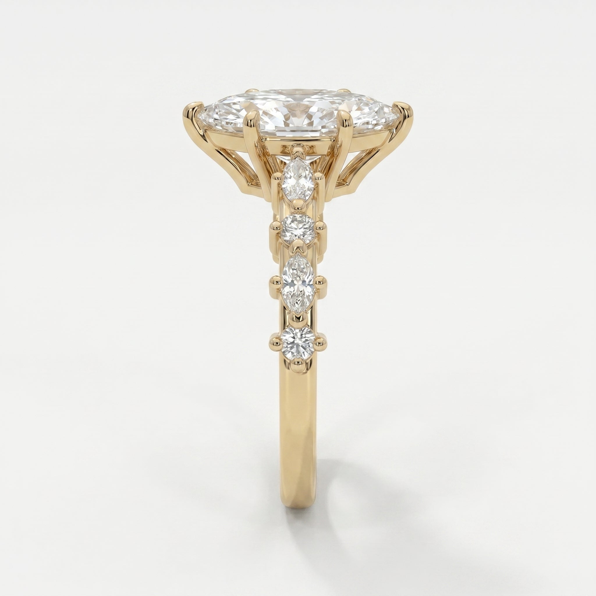 Side profile of yellow gold marquise diamond engagement ring showcasing elevated prong and gallery design
