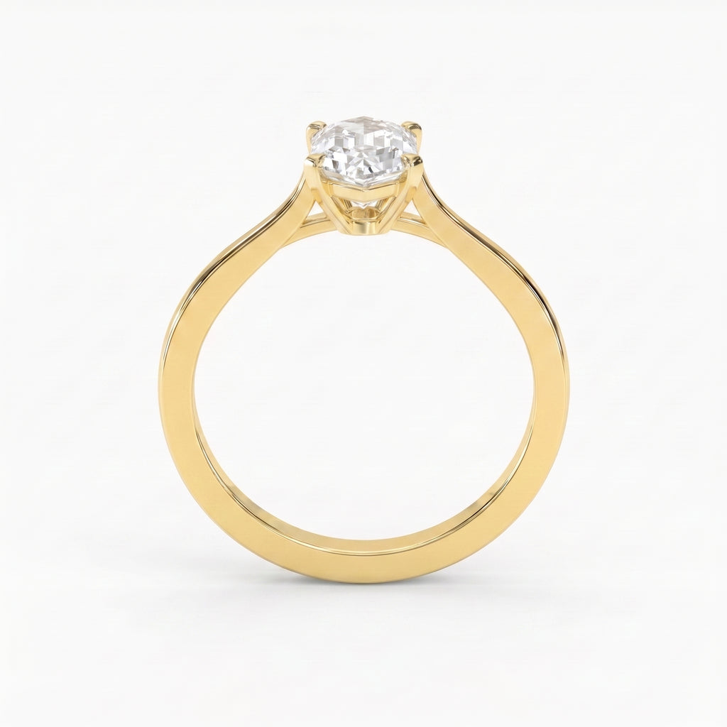 Premium elongated hexagon solitaire engagement ring featuring a step-cut diamond in a sleek four-prong polished gold setting.