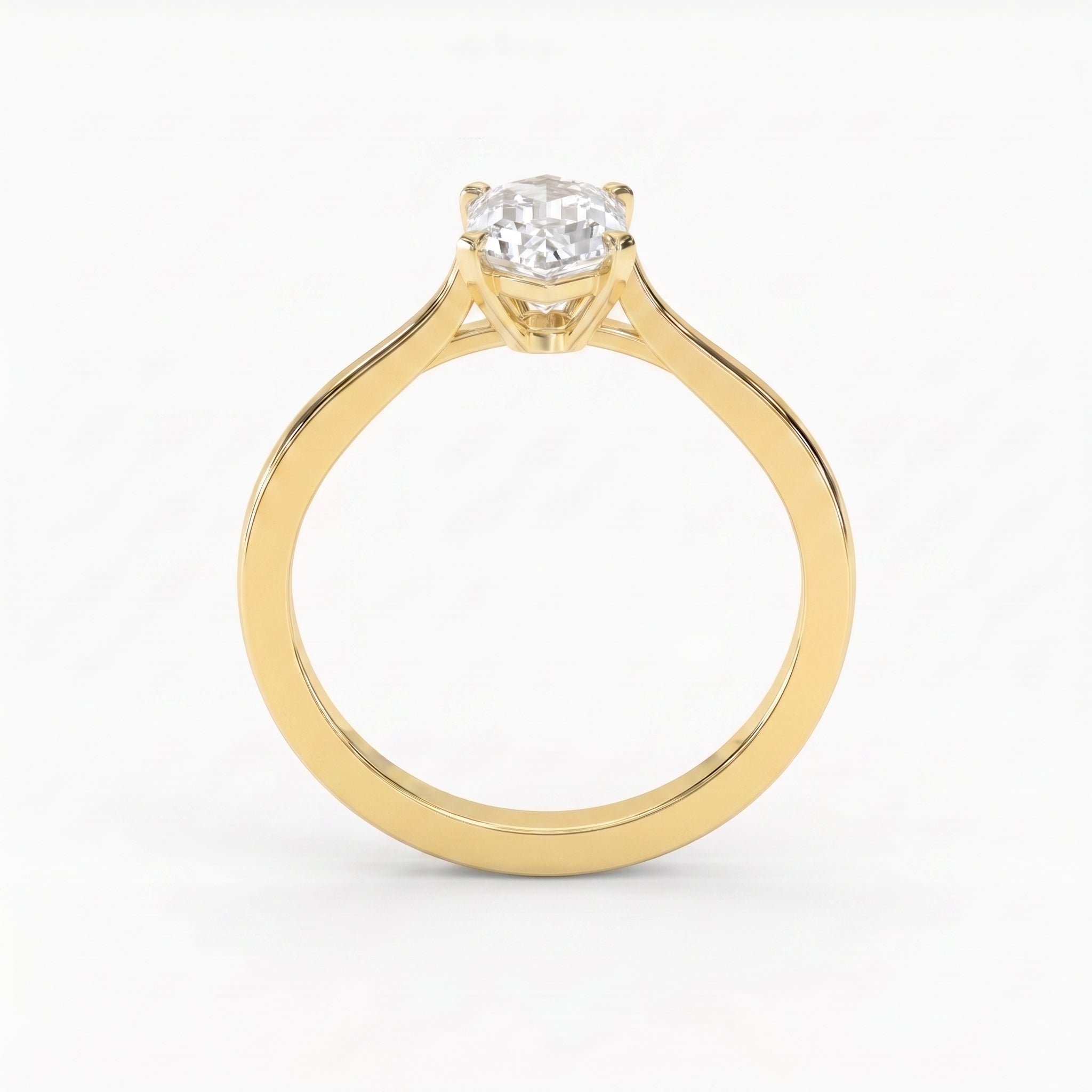 Premium elongated hexagon solitaire engagement ring featuring a step-cut diamond in a sleek four-prong polished gold setting.