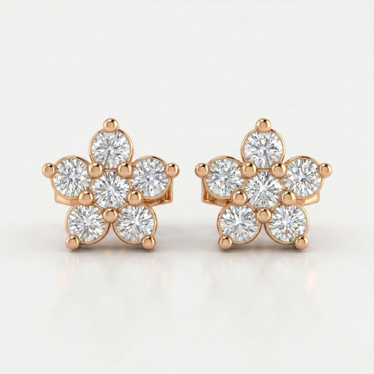 Rose gold floral diamond stud earrings with brilliant round stones on clean white luxury jewelry background