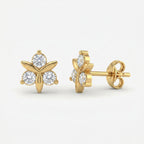 Woman wearing rose gold floral stud earrings with sparkling stones in elegant minimalist lifestyle setting