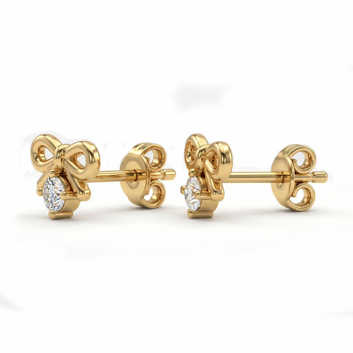 Luxury yellow gold bow diamond stud earrings with brilliant-cut stones on a clean white background