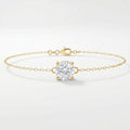 Minimalist yellow gold solitaire chain bracelet with round brilliant stone on clean white background