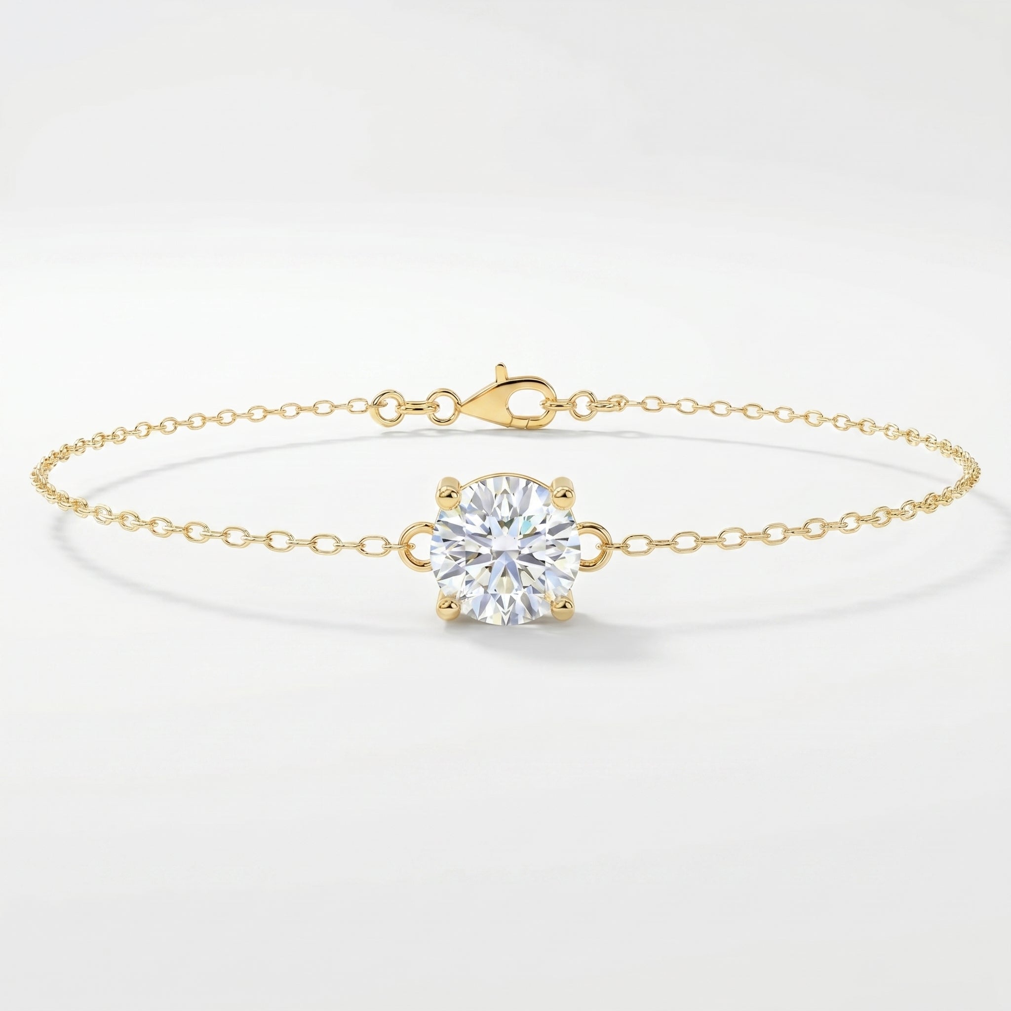 Minimalist yellow gold solitaire chain bracelet with round brilliant stone on clean white background