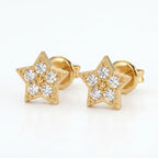 Woman wearing gold star diamond stud earrings in natural light with elegant everyday luxury styling