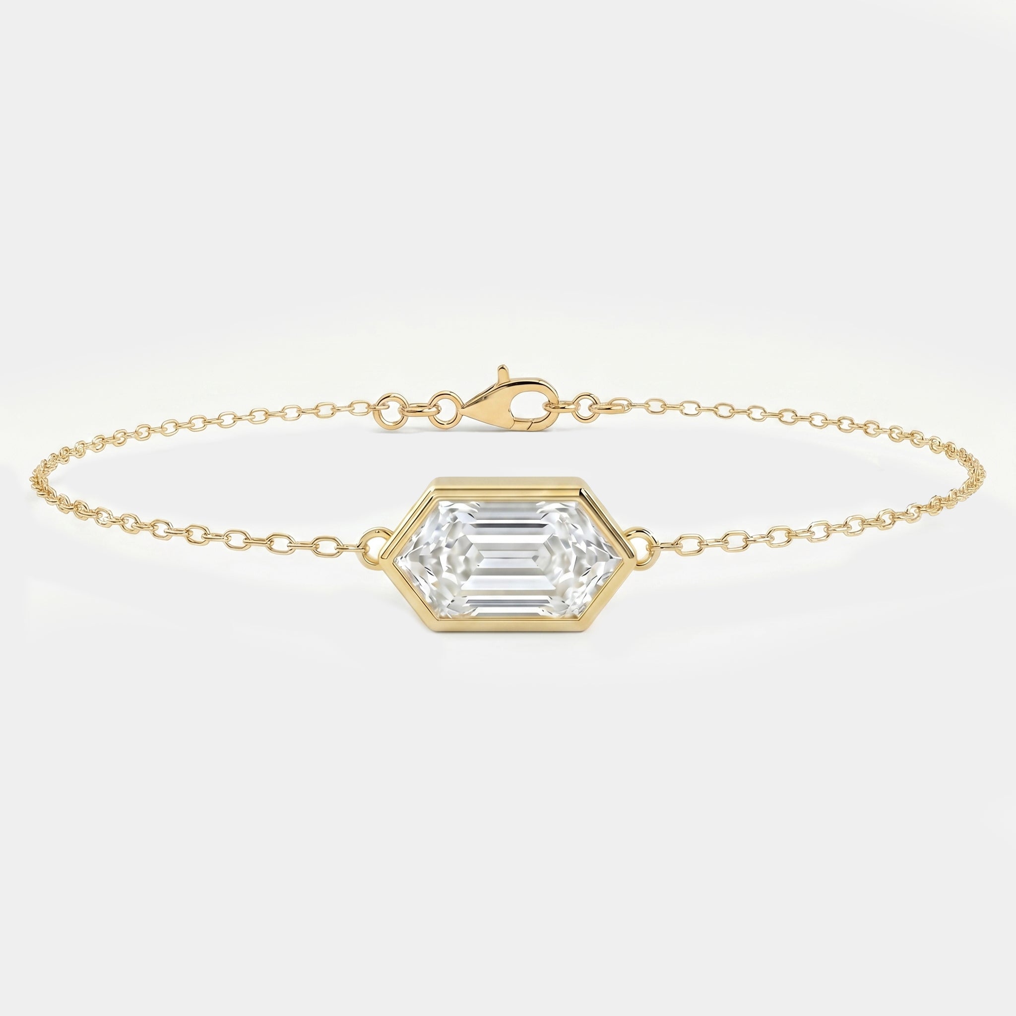Minimalist gold chain bracelet with hexagon-cut clear gemstone in bezel setting on white background