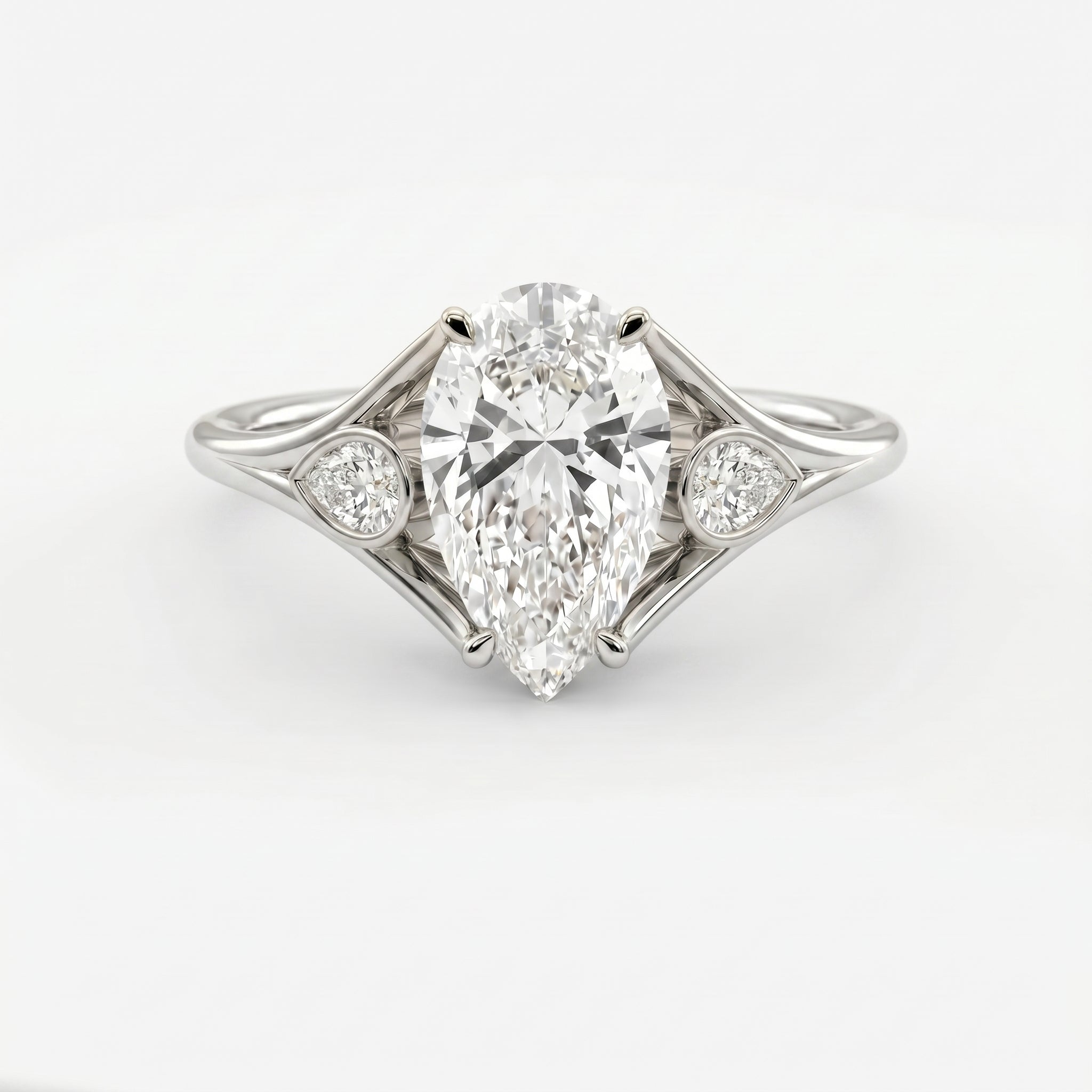 Custom 4‑Prong Diamond Ring with Bezel‑Set Pear Side Stones