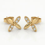 Macro close-up of pavé diamonds on butterfly stud earrings with high-polish luxury gold finish