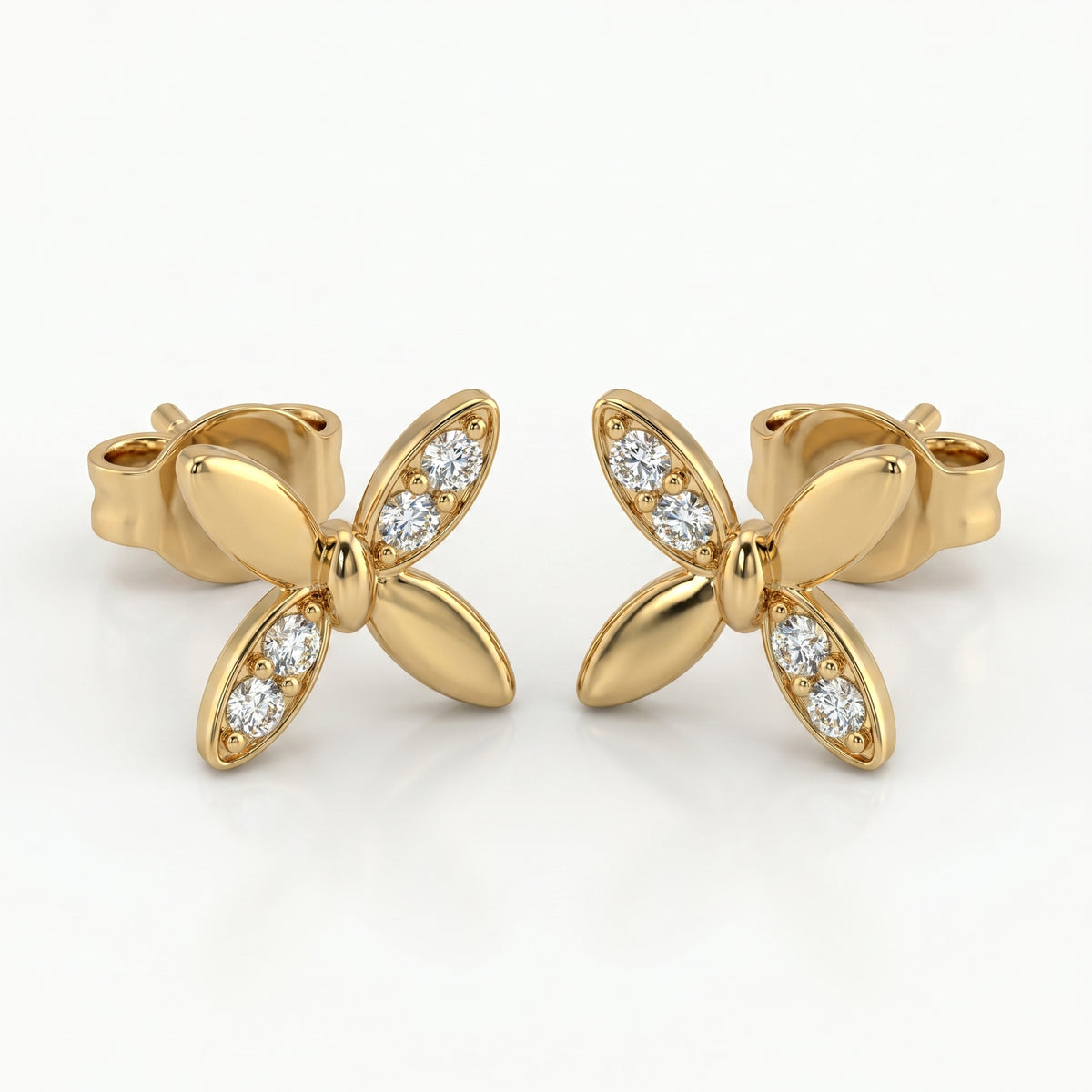 Macro close-up of pavé diamonds on butterfly stud earrings with high-polish luxury gold finish