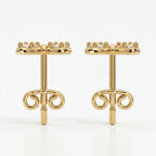 Macro close-up of pavé diamonds on butterfly stud earrings with high-polish luxury gold finish