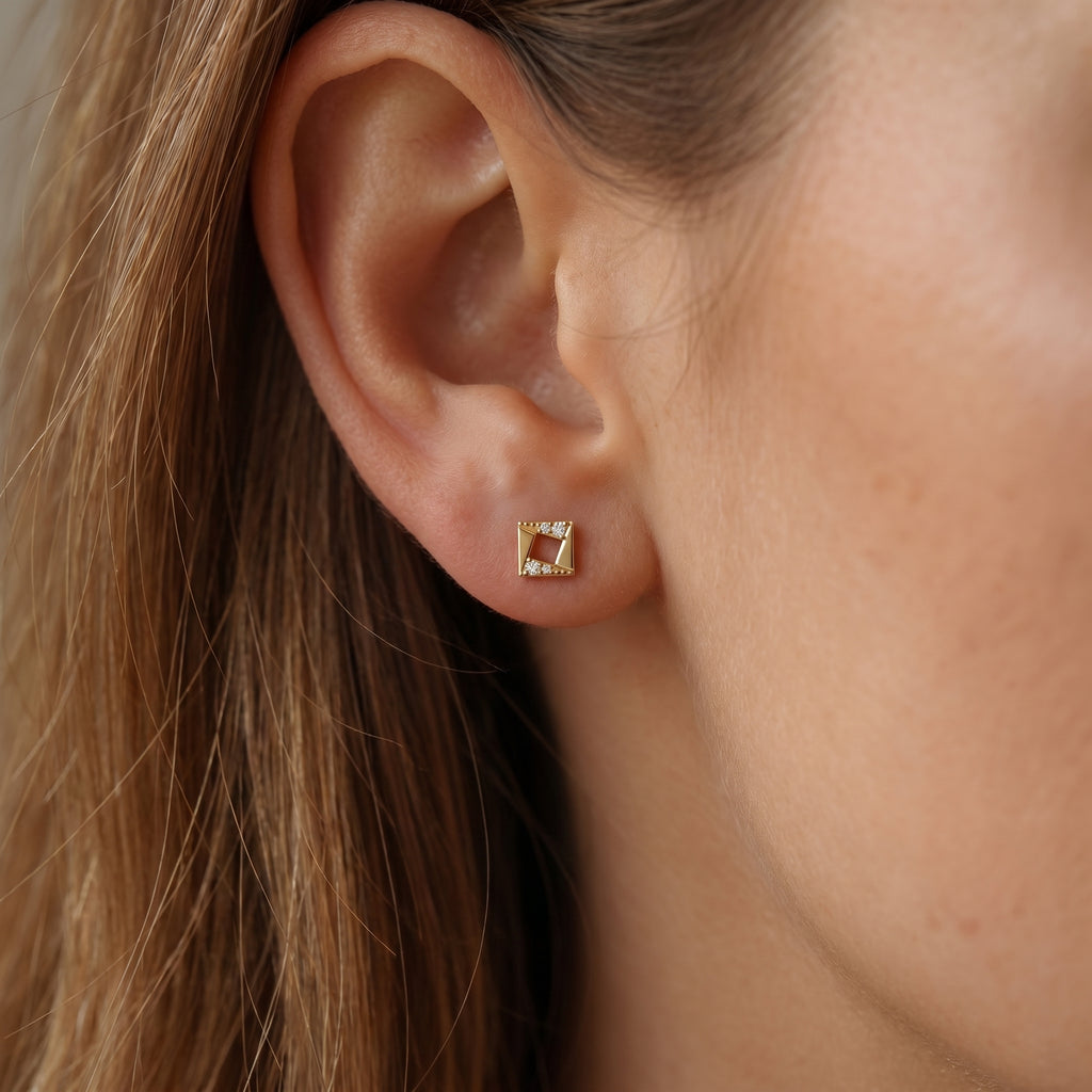 Side profile of geometric diamond stud earrings showing polished Yellow  gold craftsmanship and secure backing
