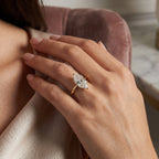 Marquise cut diamond engagement ring in yellow gold solitaire setting worn on hand with brilliant sparkle