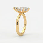 Marquise-cut diamond engagement ring in polished yellow gold with hidden halo setting and elegant cathedral profile