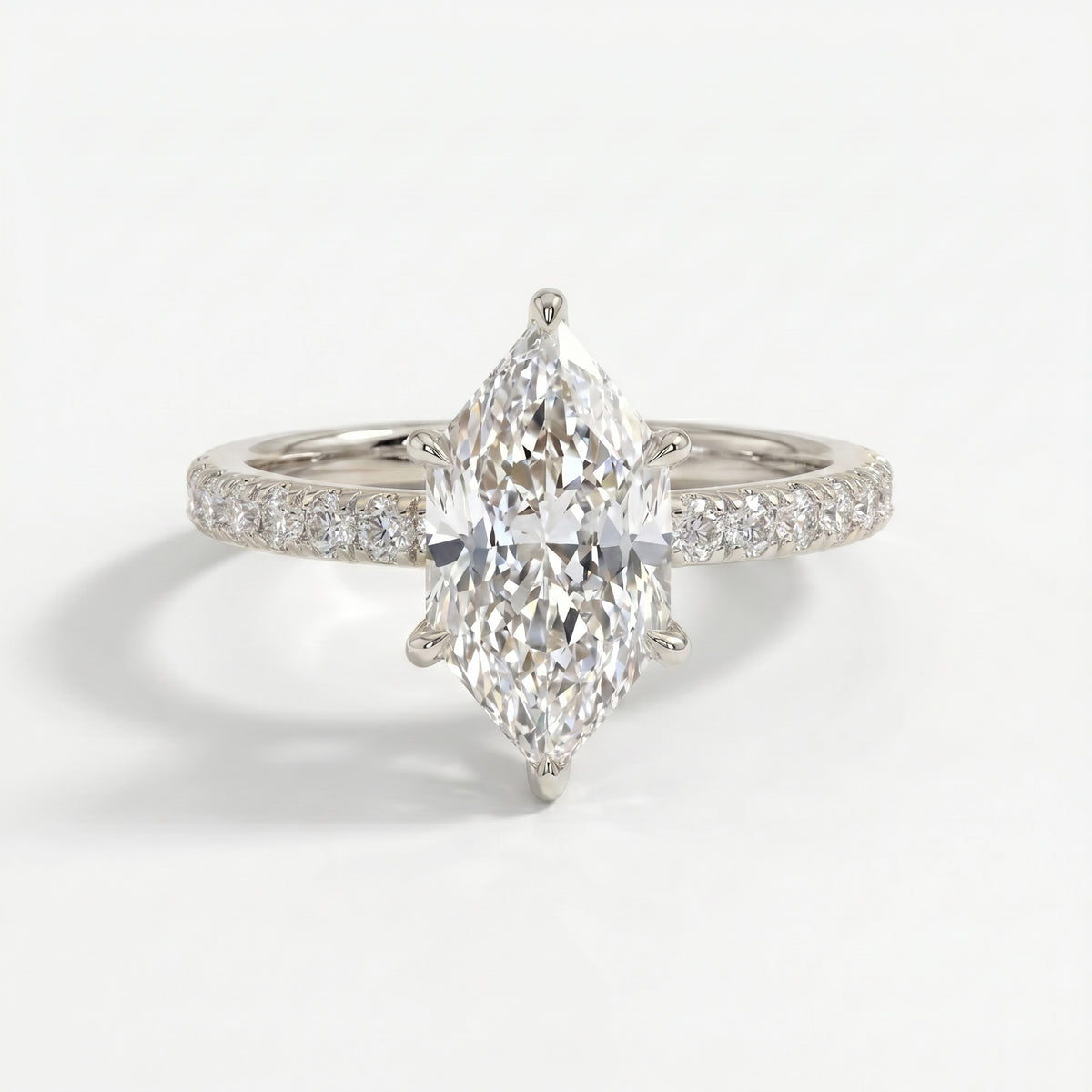 Marquise diamond engagement ring in white gold with pavé diamond band and luxury bridal design