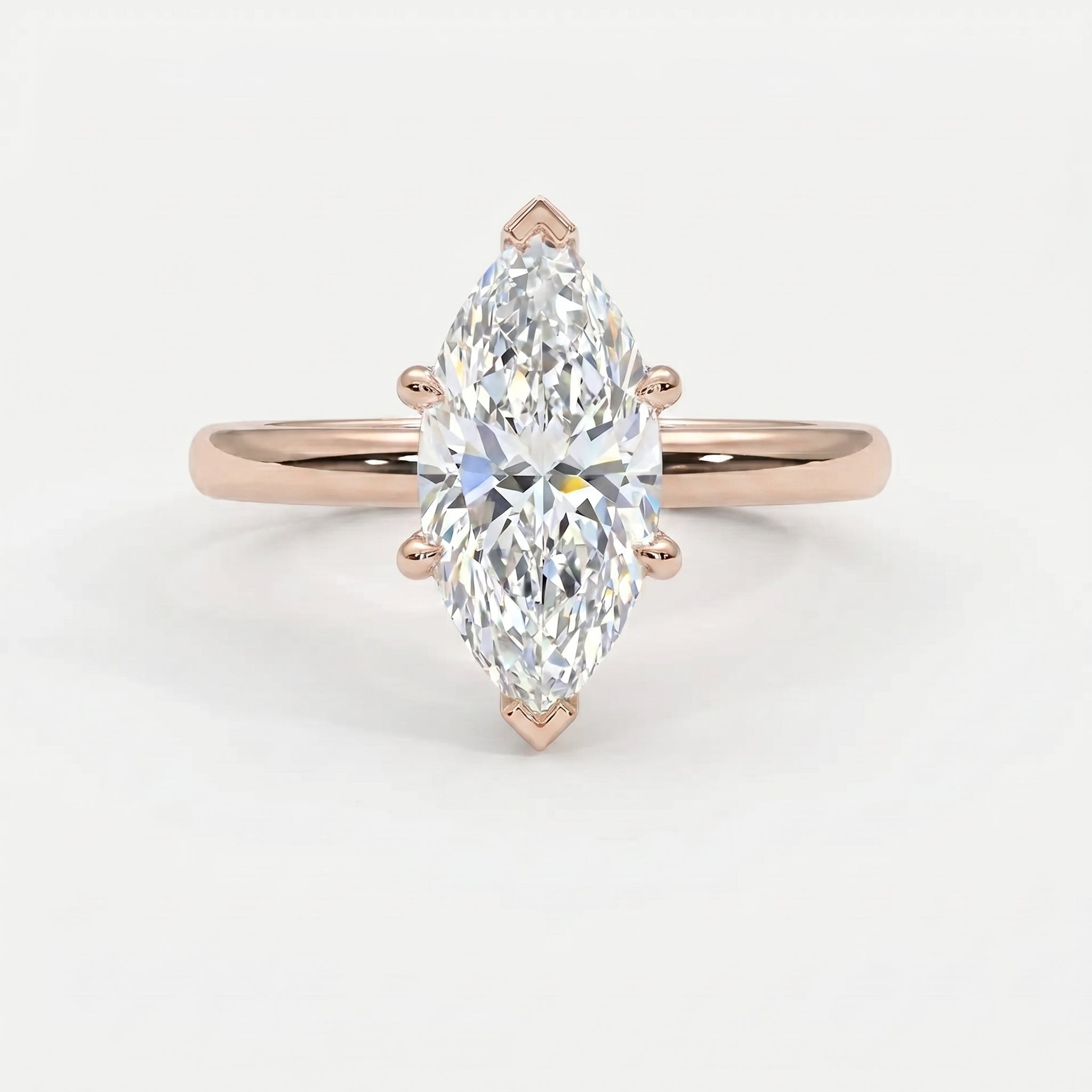 Luxury marquise diamond engagement ring featuring a rose gold band and classic solitaire prong setting.