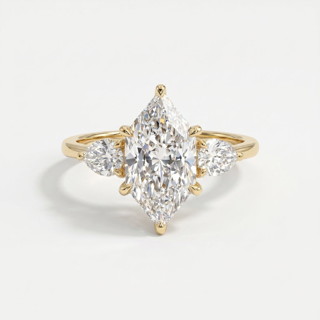 Marquise diamond three stone engagement ring in yellow gold with pear side diamonds on a clean white background