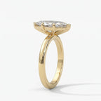 Luxury marquise solitaire engagement ring in yellow gold shown at a 45-degree angle highlighting sparkle.