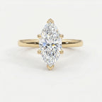 Marquise cut solitaire engagement ring in polished yellow gold with six-prong setting and brilliant center stone.