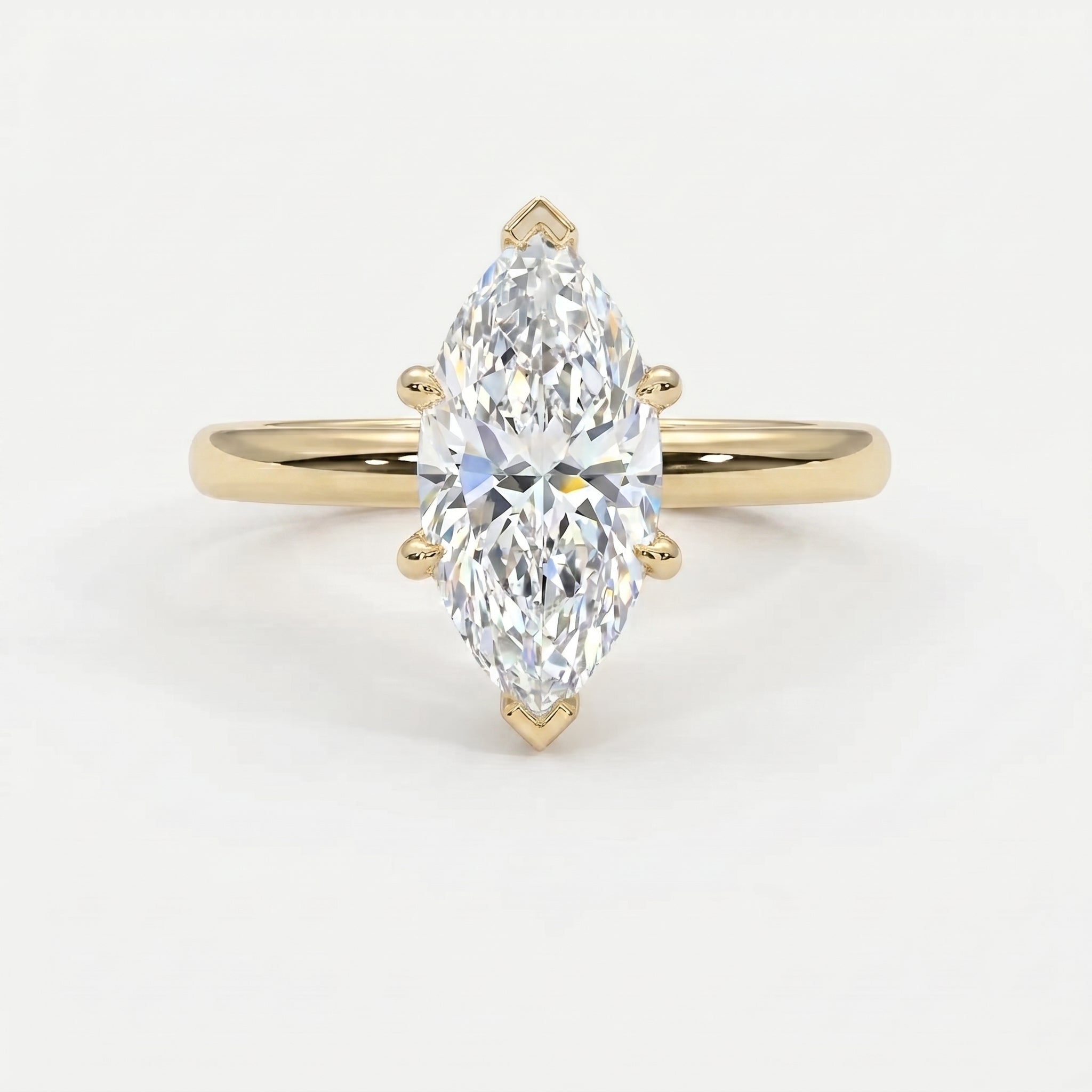 Marquise cut solitaire engagement ring in polished yellow gold with six-prong setting and brilliant center stone.
