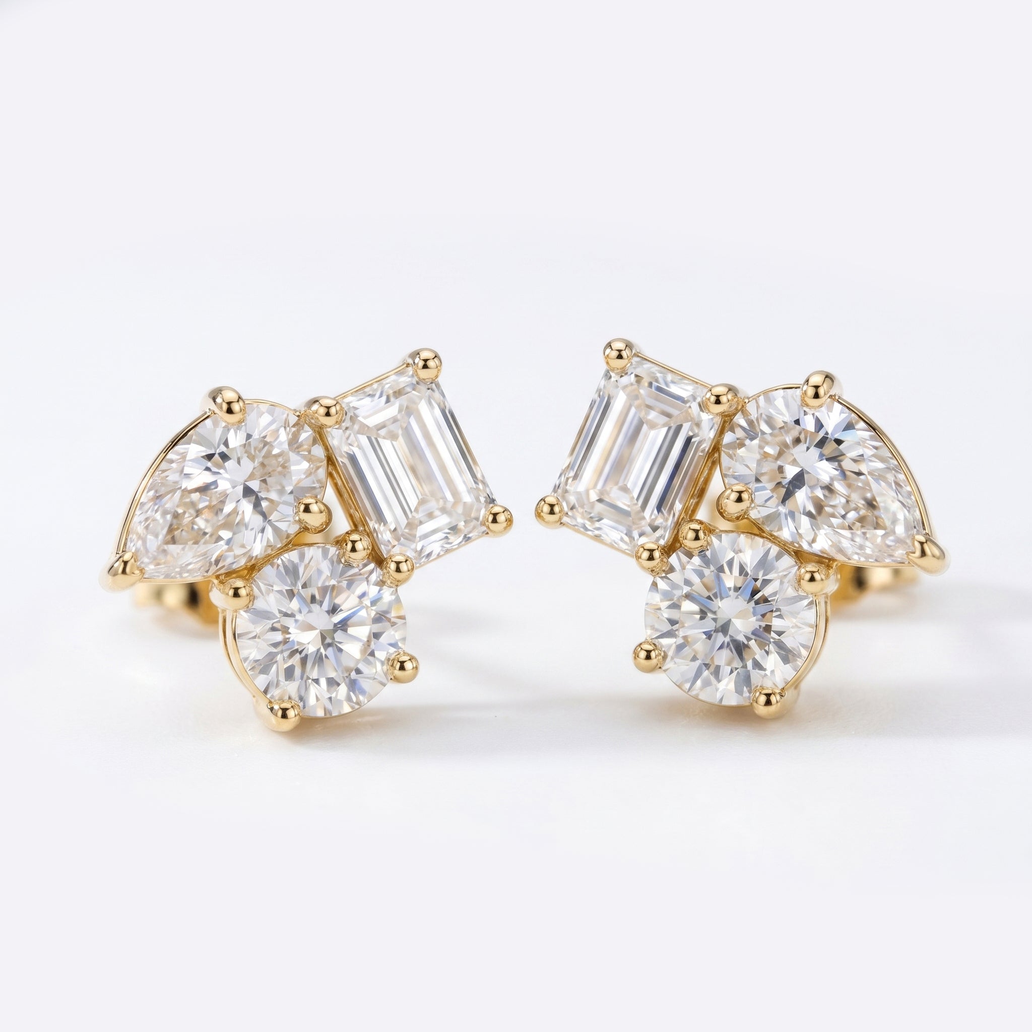 Minimalist diamond cluster stud earrings worn on ear in elegant everyday luxury styling