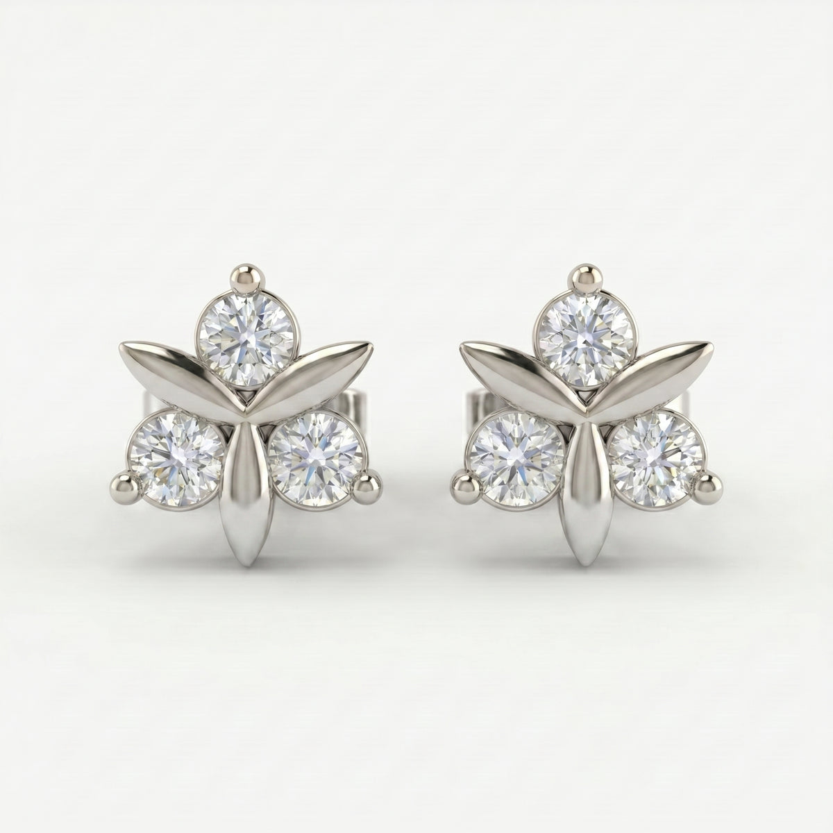 Side profile of minimalist floral stud earrings showing gemstone setting and polished rose gold craftsmanship