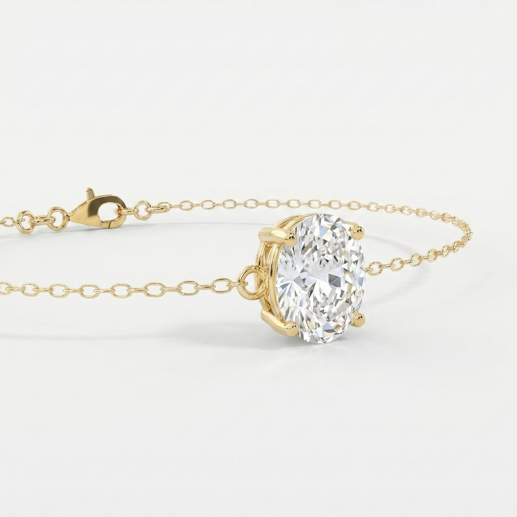 Luxury oval diamond bracelet in yellow gold shown at 45-degree angle with elegant sparkle and fine chain