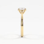 Side profile of a polished yellow gold oval diamond solitaire ring showcasing its elevated basket setting and refined cathedral-style shoulders.