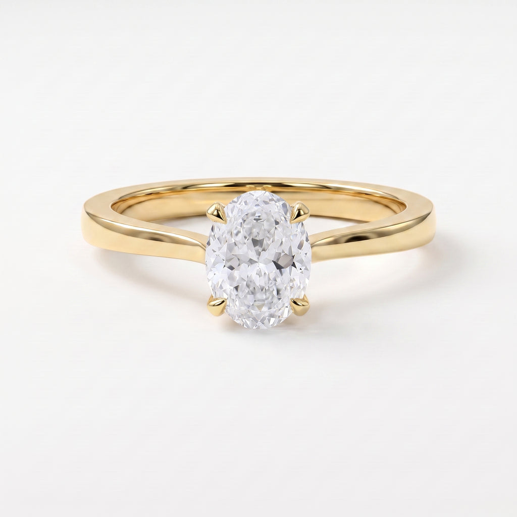 Oval Portuguese-cut diamond solitaire engagement ring in polished yellow gold with a minimalist four-prong setting.