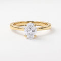 Oval Portuguese-cut diamond solitaire engagement ring in polished yellow gold with a minimalist four-prong setting.