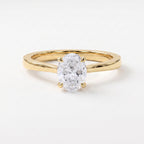 Oval Portuguese-cut diamond solitaire engagement ring in polished yellow gold with a minimalist four-prong setting.