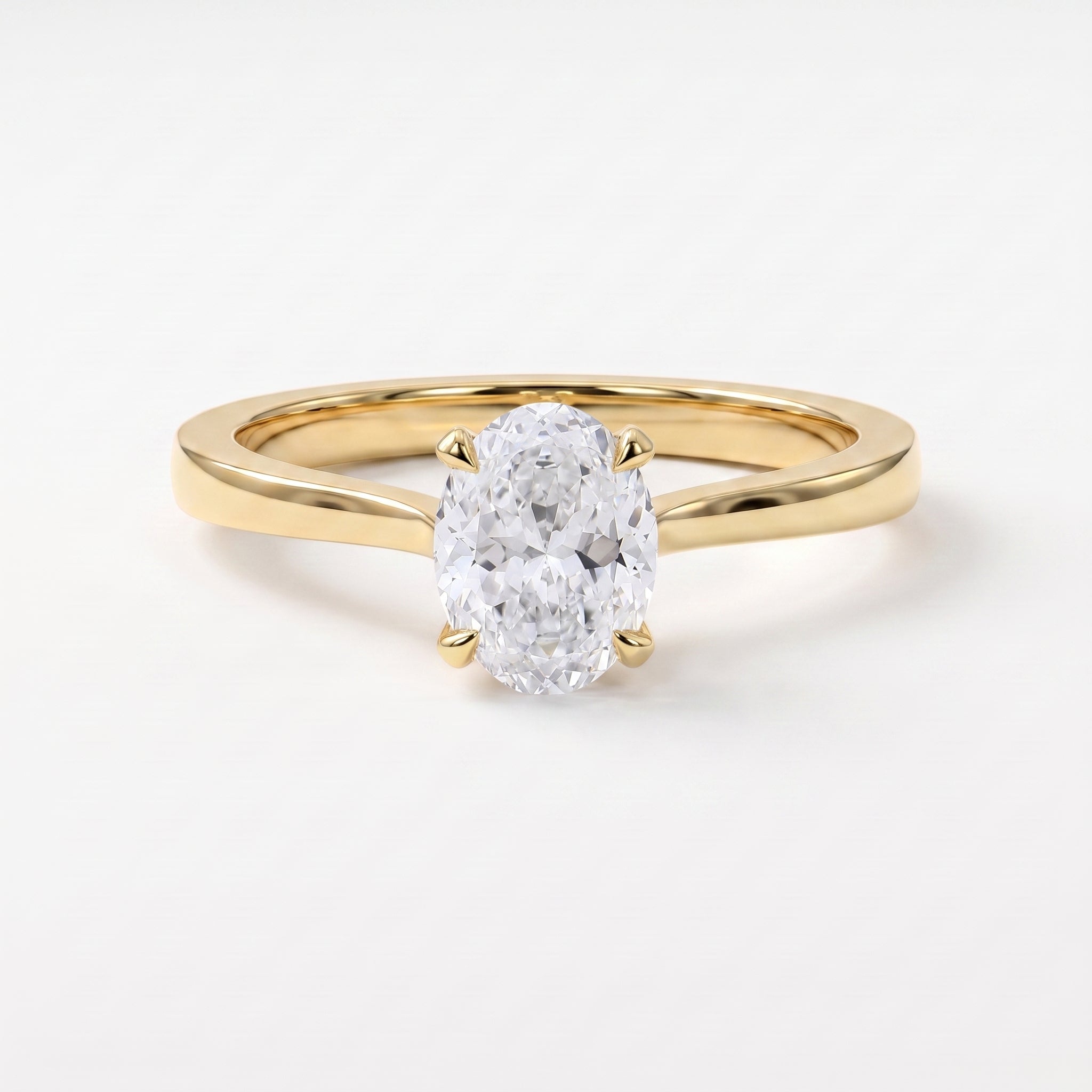 Oval Portuguese-cut diamond solitaire engagement ring in polished yellow gold with a minimalist four-prong setting.