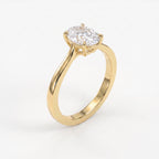 45-degree view of an oval solitaire diamond ring in yellow gold highlighting the elegant four-prong setting.
